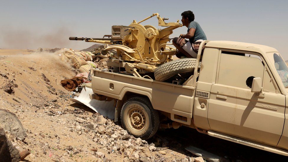 A Yemeni pro-government fighter fires a vehicle-mounted weapon towards Houthi rebels on the frontline in Marib province, Yemen (28 March 2021)