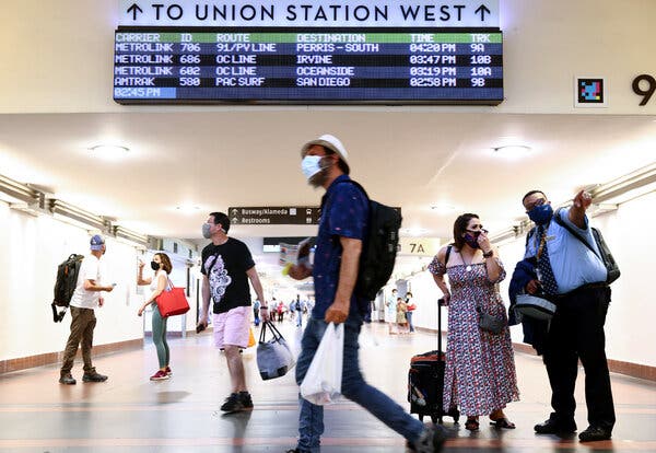 Masked travelers passing through Union Station in Los Angeles, where the mask mandate was reinstated on July 17.