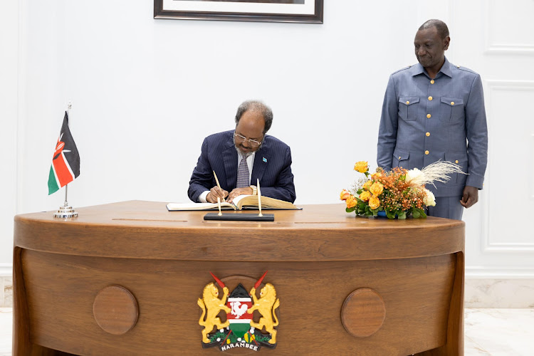 President Hassan Mohamud of Somalia signs visitors' book at State House, Nairobi, where he was hosted by President William Ruto on April 11, 2024.